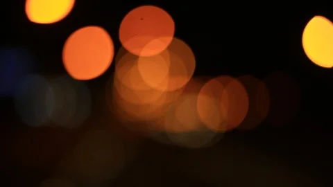 Moving bokeh seen from inside a car driving through the city. Видео 88512990