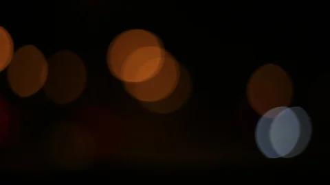 Moving bokeh seen from inside a car driving through the city. Видео 88513615