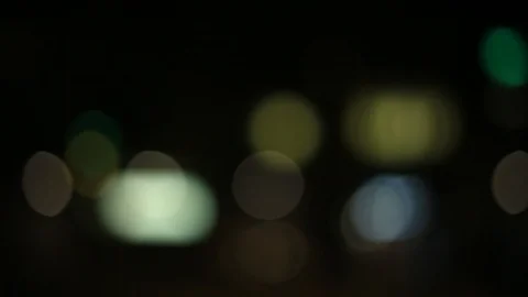 Moving bokeh seen from inside a car driving through the city. Video stock 88514294