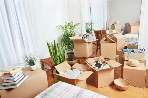 Moving boxes in new house. Stock Photos