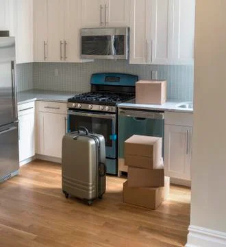 Moving boxes in new kitchen Stock Photos