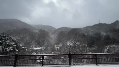 Moving Bus Window View of Snow Covered Mountain Resort Japan Winter Stock Footage 346259465