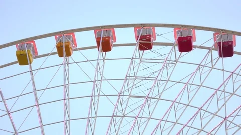 Moving cabins of Ferris wheel at day Stock Footage 72588051