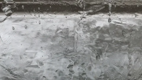 Moving camera from bottom to top through frozen glass and moving person and cars Stockbeeldmateriaal 99584524