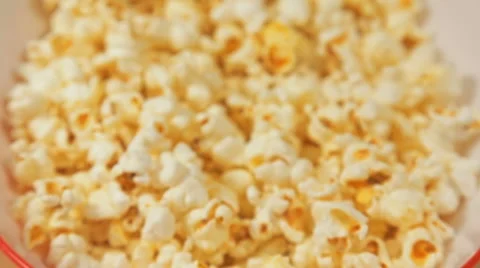 Moving camera close into the red bowl full of popcorn. Stock Footage 65114029