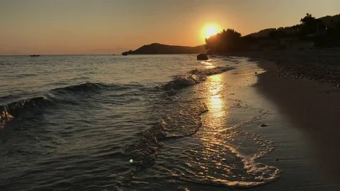 Moving camera passes bu a beach during sunset in Greece Video stock 81668727