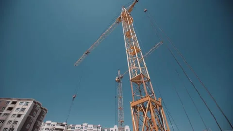 Moving camera shoots giant constructor crane in work. Stock Footage 143135286