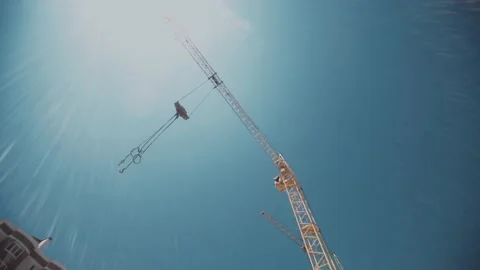 Moving camera shoots giant constructor crane in work. Stock Footage 143562479