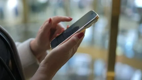 Moving camera shot female hands use smartphone in shopping mall Caucasian 30s Stock Footage 251015441