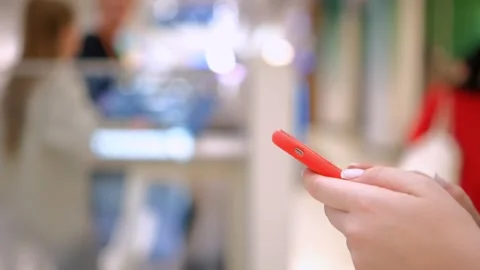 Moving camera shot female hands use smartphone in shopping mall Caucasian 30s Video stock 257798305