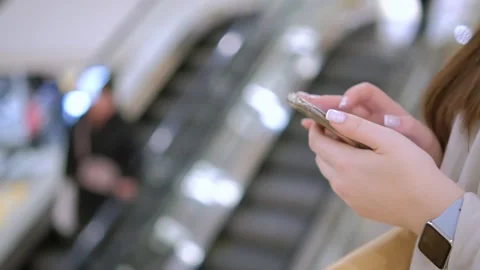 Moving camera shot female hands use smartphone in shopping mall Caucasian 30s Stock Footage 257948025