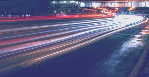 Moving car with blur light through twilight city. Stock Photos