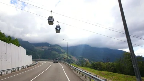 Moving in car on road under funicular among foggy mountains at summer, Sochi, Stock Footage 276363352