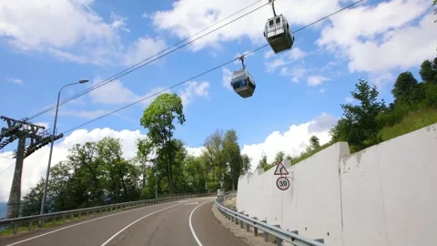 Moving in car on road under funicular in mountains at summer, Sochi, Russia Stock Footage 276363358