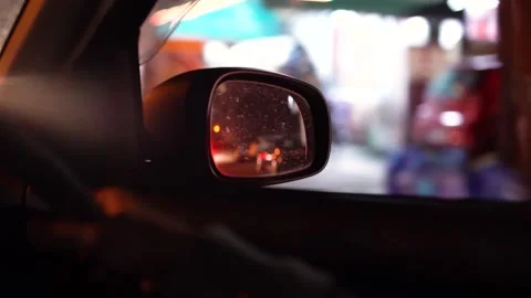 Moving car side mirror view of city streets at night Stock Footage 133261127