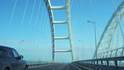 Moving on car through white arch on Crimean Bridge between Taman and Kerch Stock Footage 105054111