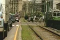 Moving car traffic beside tram line Footage