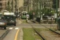 Moving car traffic beside tram line Footage