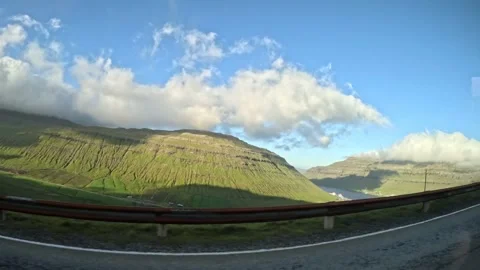 Moving car window view of a road trip through green volcanic hills Stock Footage 339096811