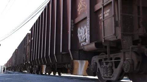 A moving cargo transport train filmed low to the ground in Augusta Georgia Stock Footage 149036010