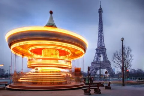 Moving carousel close to eiffel tower, paris Stock Photos