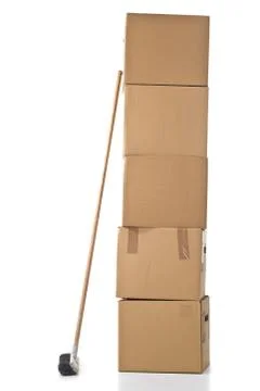 Moving carton boxes stack with broom 스톡 사진