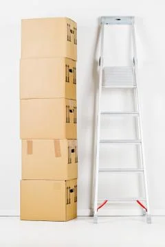 Moving carton boxes stack with ladder 写真素材