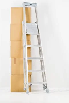 Moving carton boxes stack with ladder 写真素材