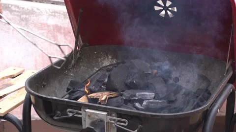 Moving the charcoal on a grill Video stock 143347956
