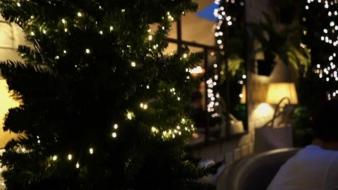 Moving up Christmas tree in restaurant while guests sit in the booth Stock Footage 106810600