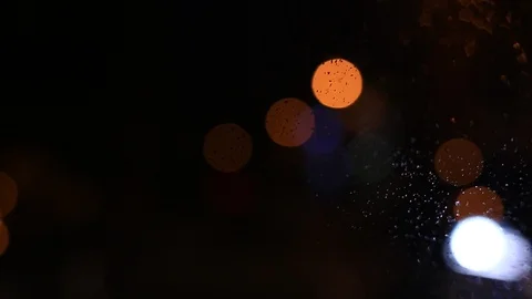 Moving city bokeh at night from behind the windscreen of a moving car. Stock Footage 88417355