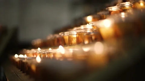Moving close up of Candles in church Bali Indonesia Prayer candles hinduism Stock Footage