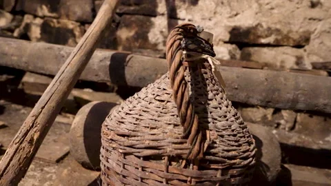 Moving Close-Up of Glass Demijohn with Wicker Sleeve Stock Footage 345990307