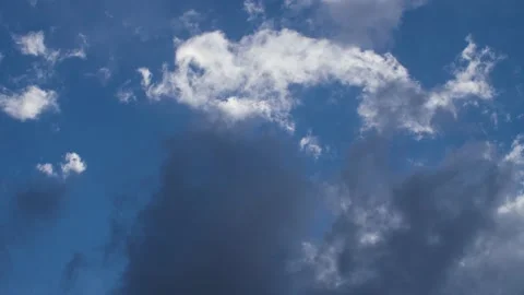 Moving close up of white and gray storm clouds with blue sky in background. Stock Footage 156954901