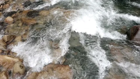 Moving closely over a quick current in a mountain stream with blue water Video stock 160327753