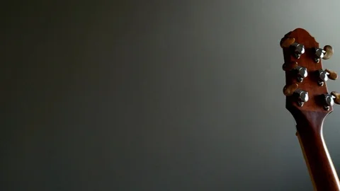 Moving closer to the back of the head of an acoustic guitar Stock Footage 114846024