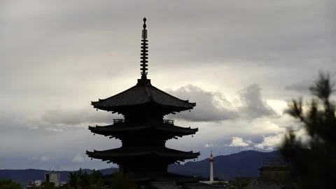 Moving cloud over the ancient Yasaka Tower and Model Kyoto Tower Stock Footage 141092518