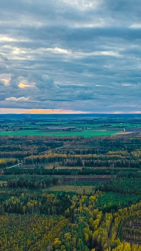 Moving clouds above autumn forest patchwork farmland Latvia countryside Stock Footage 340429019