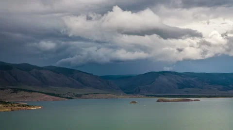 Moving clouds above a big lake Stock Footage 56885248