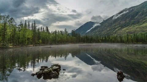 Moving clouds above a mountain lake Stock Footage 55170043