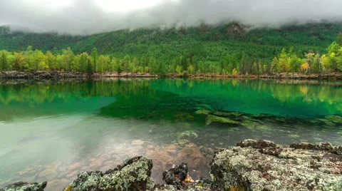 Moving clouds above a mountain lake Stock Footage 60282648