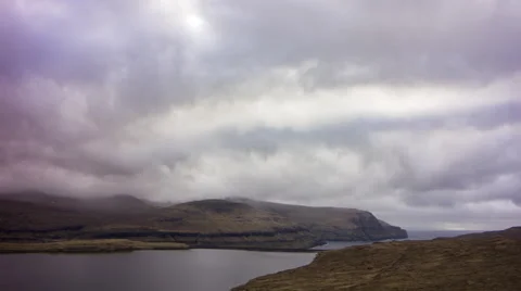 Moving clouds above the mountains and a lake, Faroe Islands, 4K time lapse Stock Footage 65306313