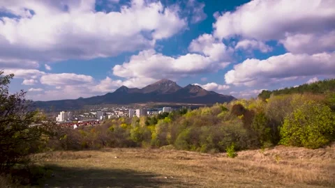 Moving clouds across the blue sky over the city and mountain peaks Stock Footage 149380327