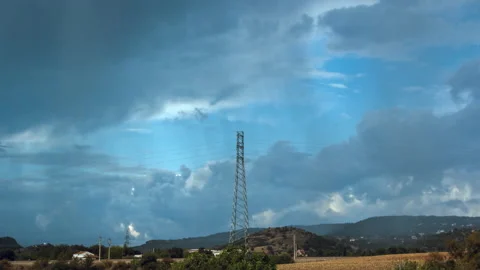Moving Clouds And Rain  Over Dry Field With Transmission Tower - Time Lapse Vídeo Stock 146301469