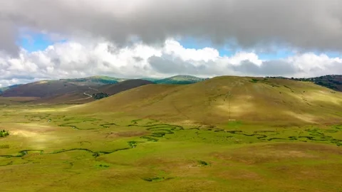 Moving clouds and shadows over the hills and field. Landscape timelapse video Stock Footage 288185108