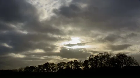 Moving clouds and sun rays during sunset in autumn, 4K timelapse Video stock 79725426