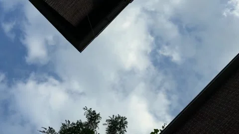 Moving Clouds Between Old Brick Buildings, Dramatic Low Angle Urban Sky Stock Footage 342343789