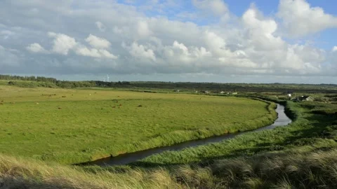 Moving clouds casting shadows over rural landscape Stock Footage 338082702