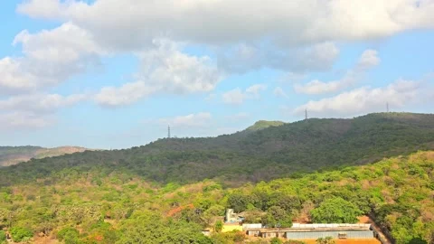 Moving Clouds creating beautiful shadows on a mountain with houses Video stock 157380639