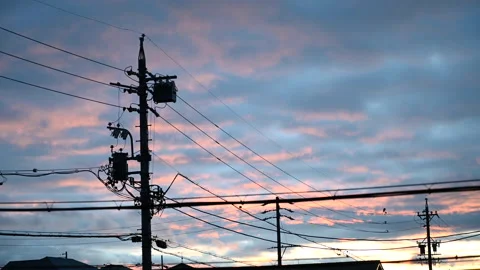 Moving clouds on an evening vanilla sky. Utility poles and electrical wires. Stock Footage